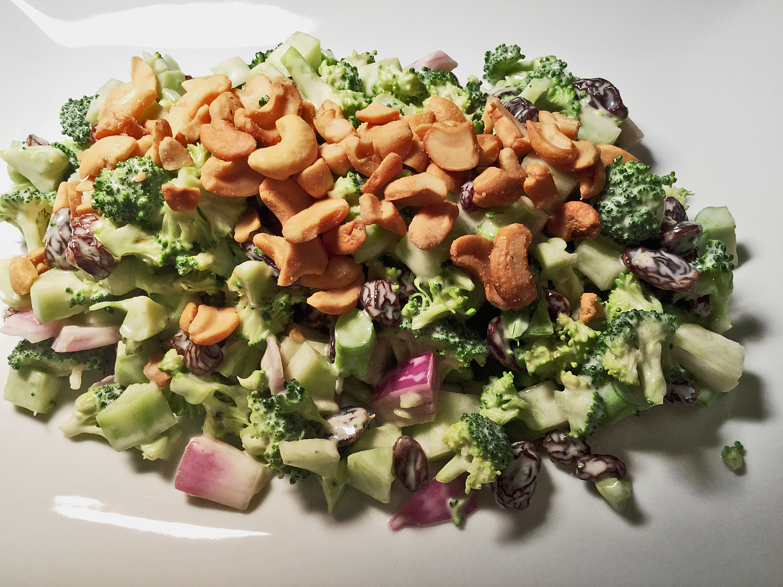 This raw broccoli salad recipe is made with raisins and topped with cashews!